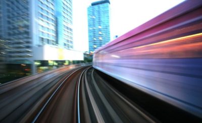a photo of a train rider's view of a railway as the train lurches forward on its tracks amid the emergence of urban rail systems