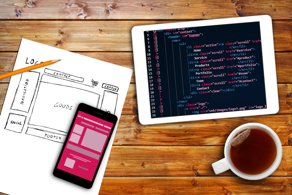Bold Business Mobile App Development mobile app and tablet on table with coffee cup