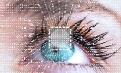 a photo of a futuristic eye with data and computer chip amid mankind's search for the cure for blindness