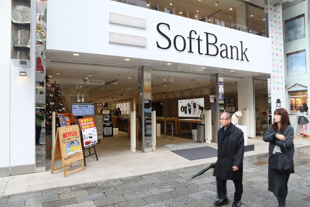photo of a SoftBank building entrance—owned by SoftBank CEO Masayoshi Son —with people walking outside it a photo of a SoftBank building entrance—owned by SoftBank CEO Masayoshi Son —with people walking outside it