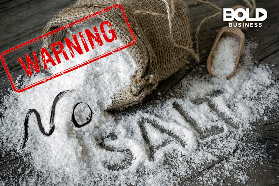 spilled salt on a table top with the words "No Salt" engraved on the scattered salt and a stamped word "WARNING" near the bag from where the salt spills amid the availability of heart-healthy cooking classes a photo of spilled salt on a table top with the words "No Salt" engraved on the scattered salt and a stamped word "WARNING" near the bag from where the salt spills amid the availability of heart-healthy cooking classes
