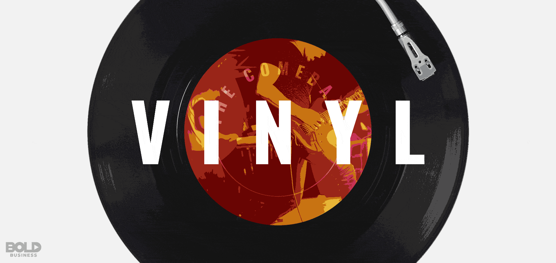 Album on record player with vinyl text on top.