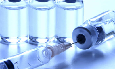 syringe and a vial of vaccine