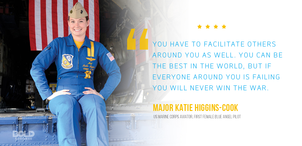 female blue angels pilot katie higgins cook seated at the back of a truck