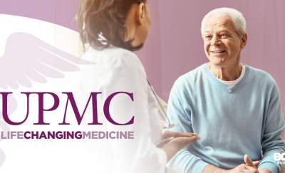 a photo of the University of Pittsburgh Medical Center logo beside a doctor talking with an elderly employee