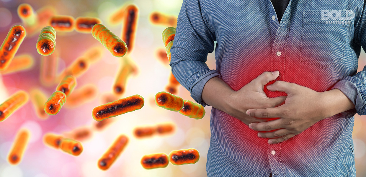 a man holding his stomach in pain beside magnified images of gut bacteria amid the search for effective functional dyspepsia treatment a photo of a man holding his stomach in pain beside magnified images of gut bacteria amid the search for effective functional dyspepsia treatment