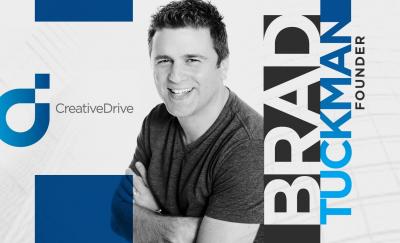 a photo of Brad Tuckman posing with arms crossed beside a logo of the company he founded, Creative Drive