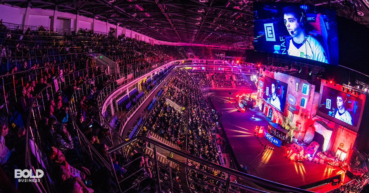 photo of an esports industry video game tournament with a hall that's full of viewers looking at a huge screen in front with a face of an esports gamer focused on playing the video game in front of him a photo of an esports industry video game tournament with a hall that's full of viewers looking at a huge screen in front with a face of an esports gamer focused on playing the video game in front of him