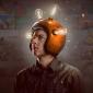 a photo of a man wearing a helmet with lighted bulbs, symbolizing the advancements in brain computer interface today