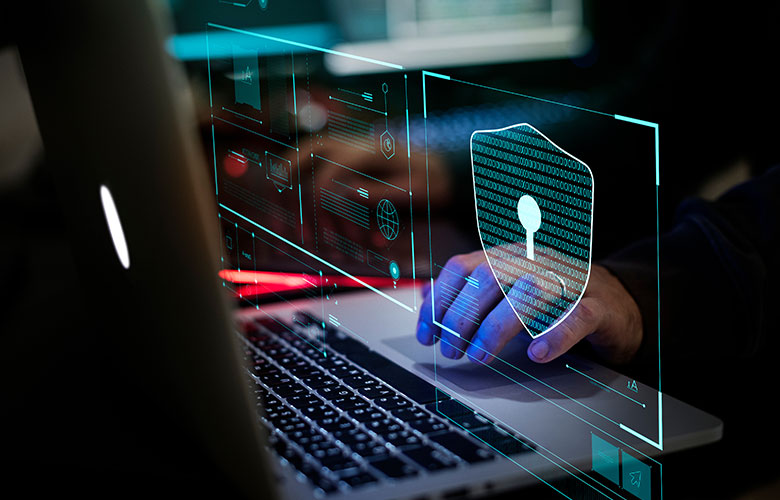 someone at a laptop with cybersecurity
