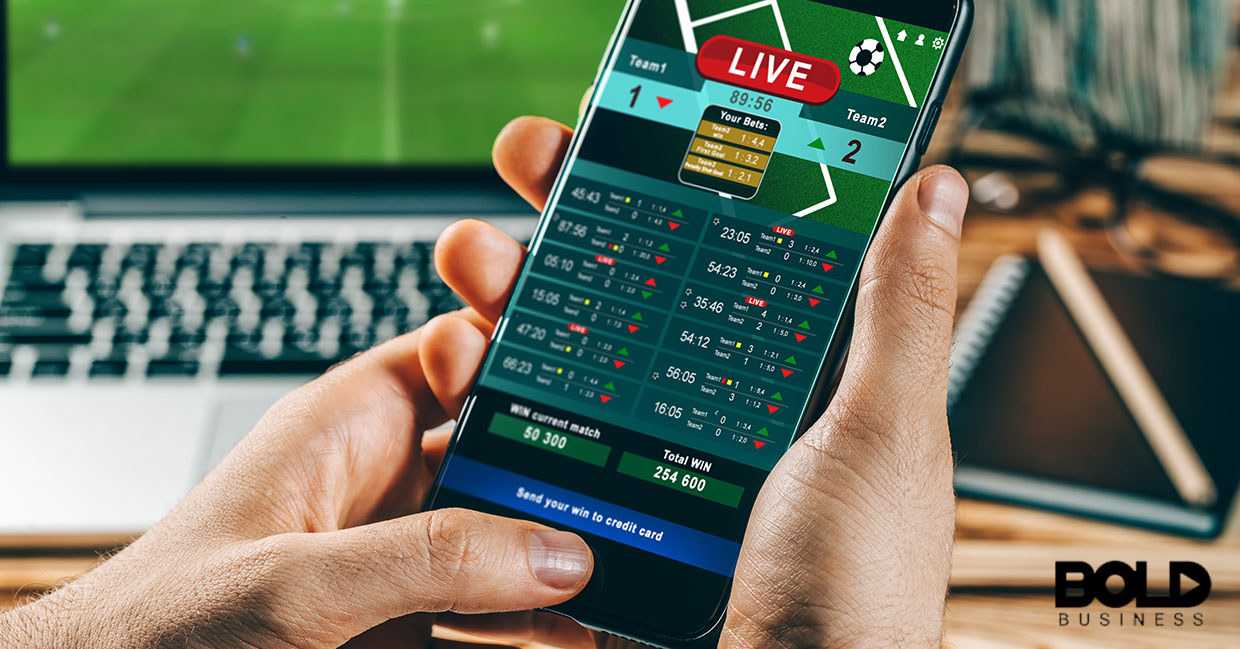 A person holding some sort of sports app