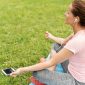 some girl meditating in the park with a mental health app