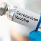 A scientist with a coronavirus vaccine in a vial