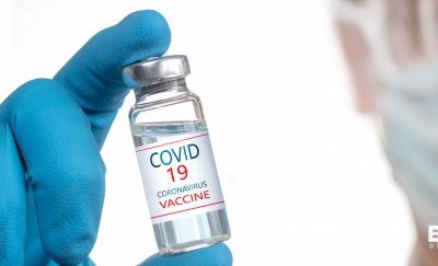 A doctor holding a vial of precious COVID vaccine