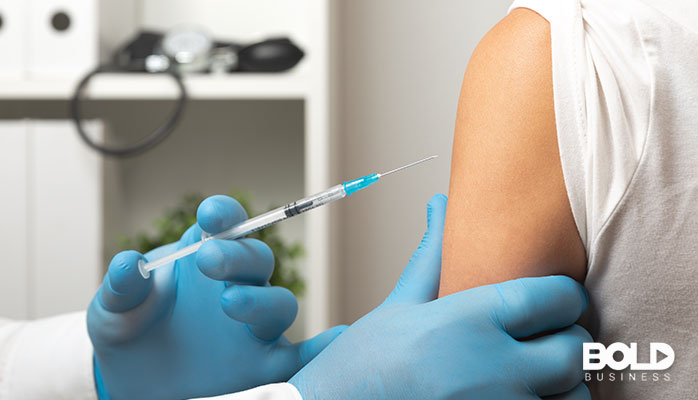 A patient getting a vaccination in their arm