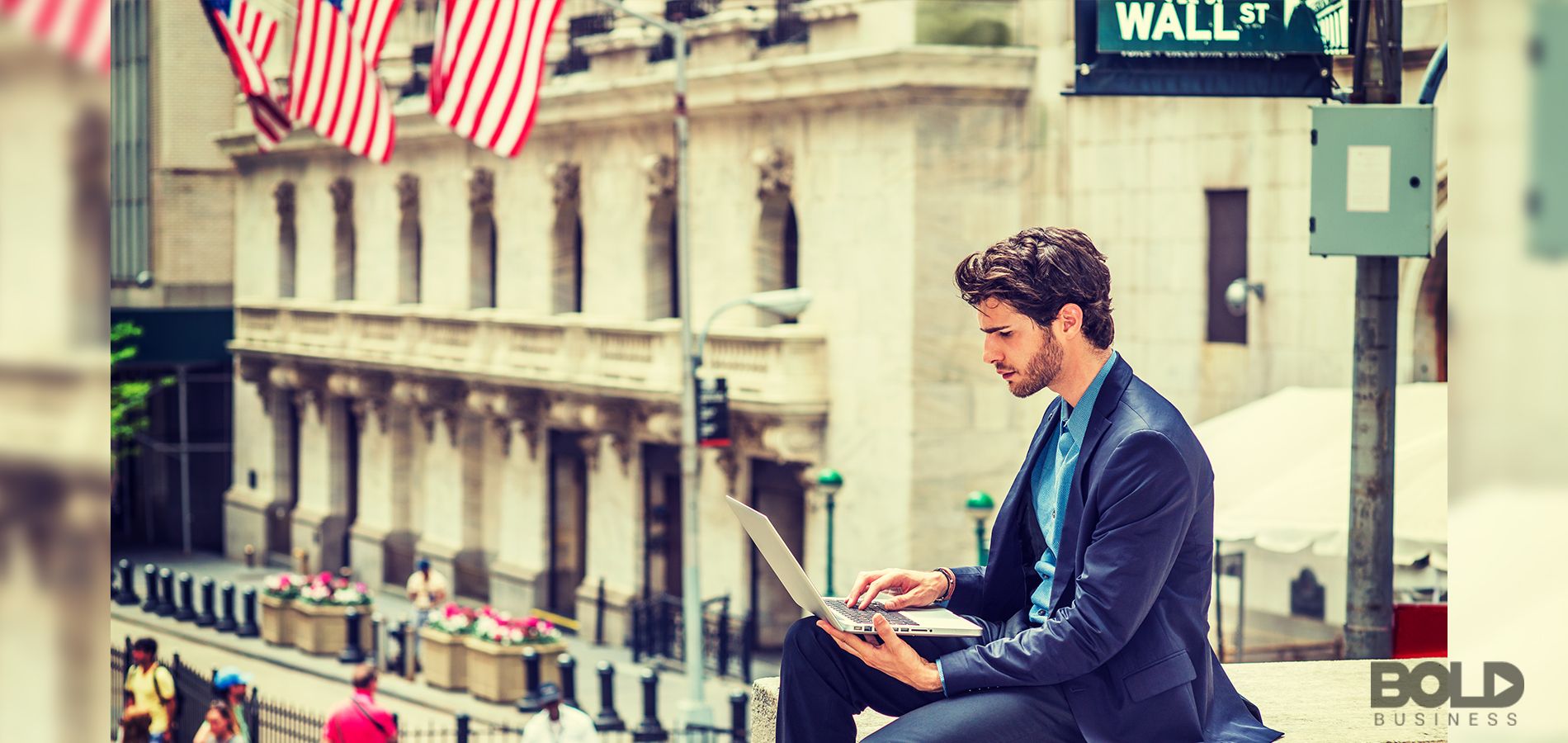 A dude using a trading app while sitting above Wall Street like a gargoyle