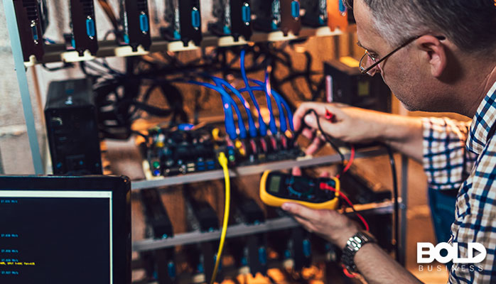 Some dude checking the voltage of some servers