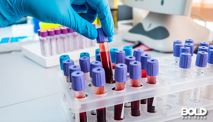 A lab tech handling some blood vials