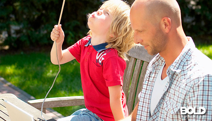 A dude trying to work but he's distracted by a kid