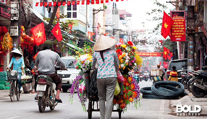 A Vietnamese woman pushing a cart