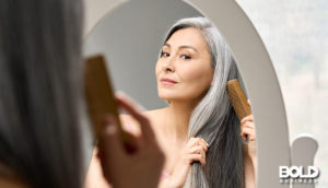 A woman brushing her hair with menopause products