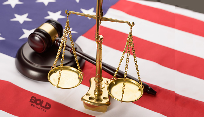 the scales of justice, a gavel and a flag