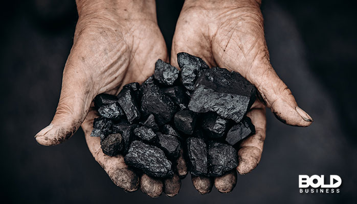 someone holding some coal in their hands